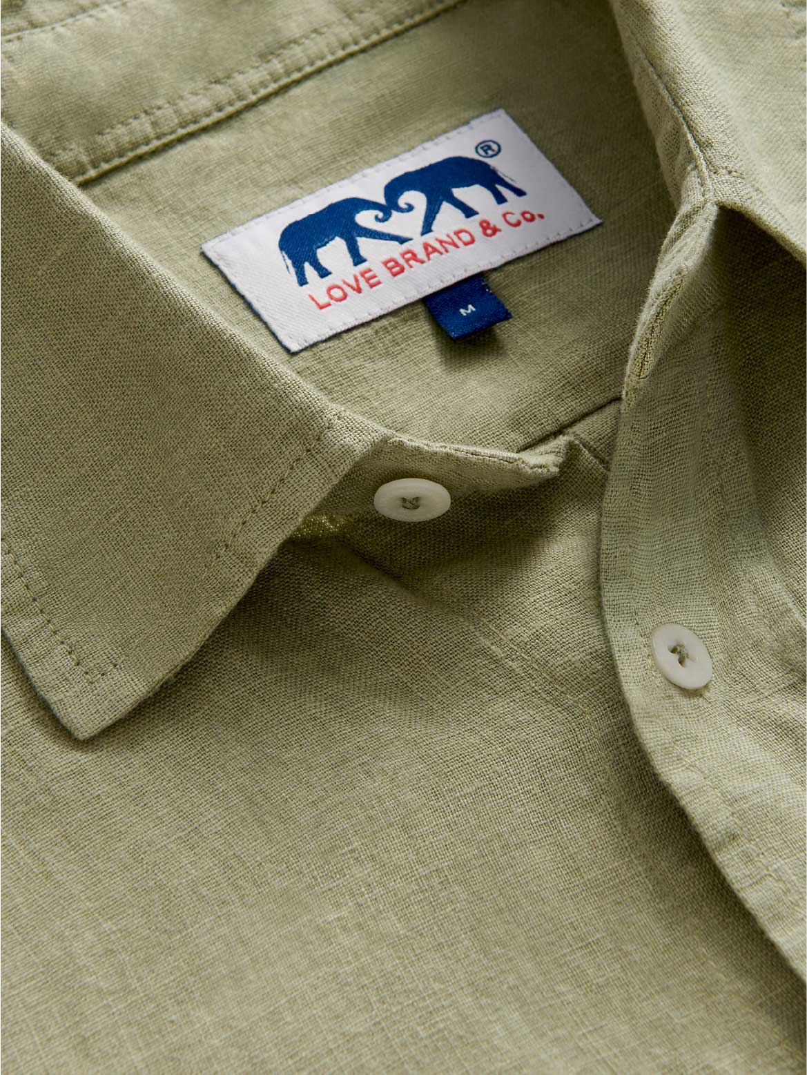 Close-up view of Men's Kerala Green Linen Shirt showing olive green linen fabric and classic collar.