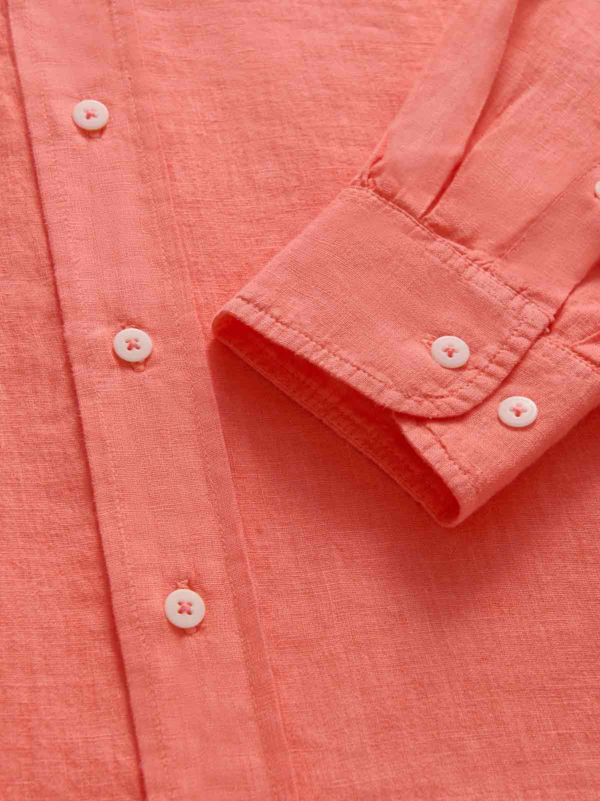 Close-up view of the cuff of a pink mens linen shirt by love brand