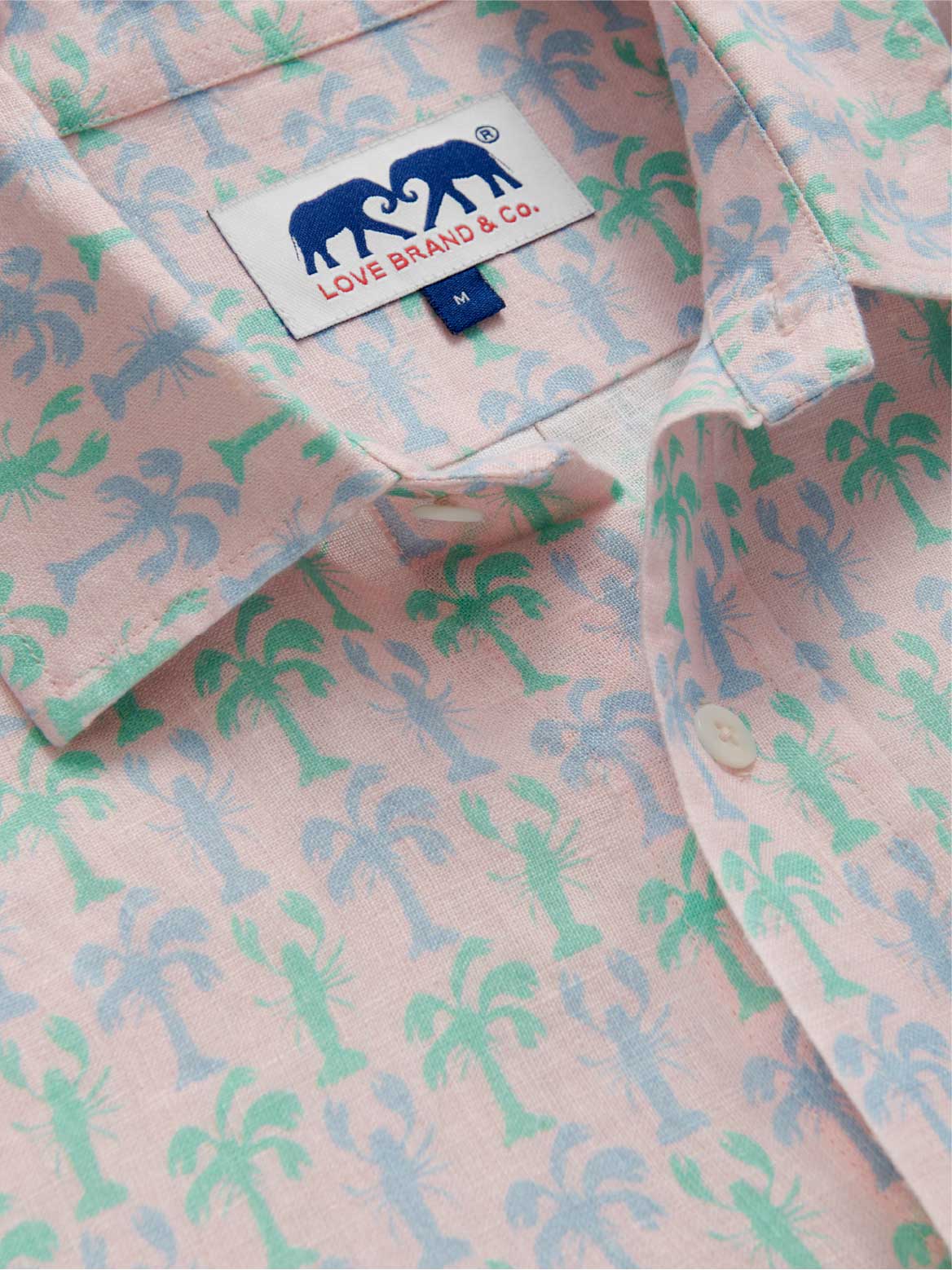 Pink shirt with tropical palm tree and lobster pattern and Love Brand & Co. label.