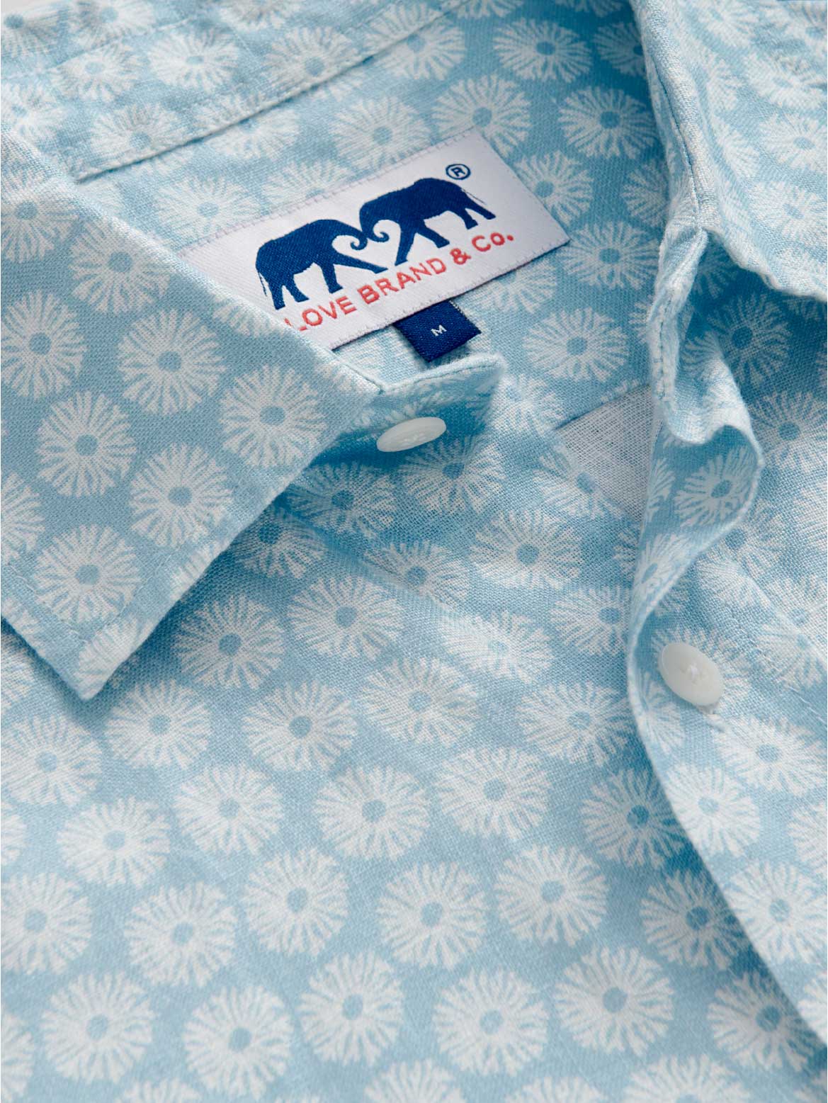 Light blue shirt with white coral pattern and Love Brand & Co. tag.