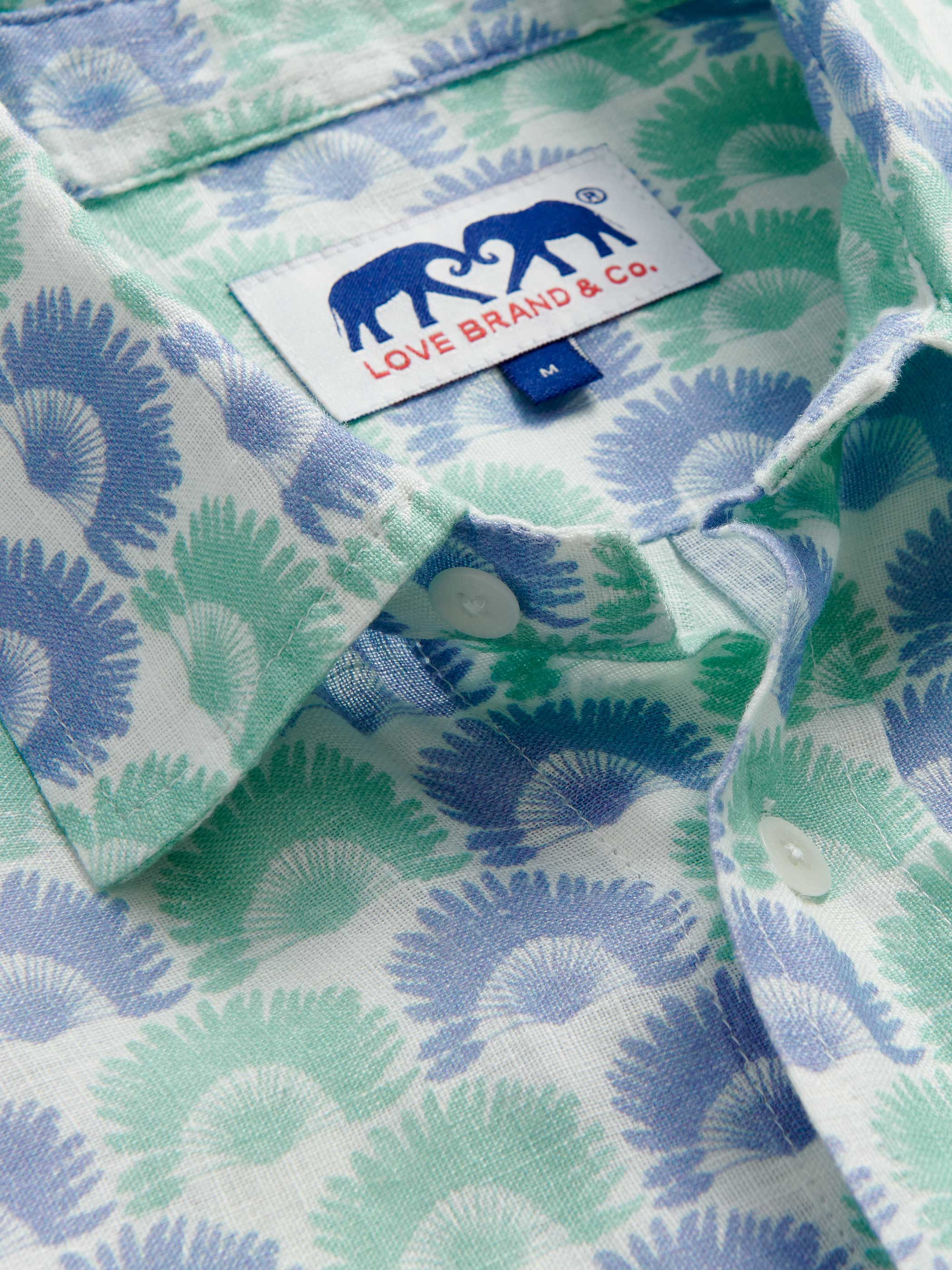 Close-up of a patterned shirt with a visible love brand label.