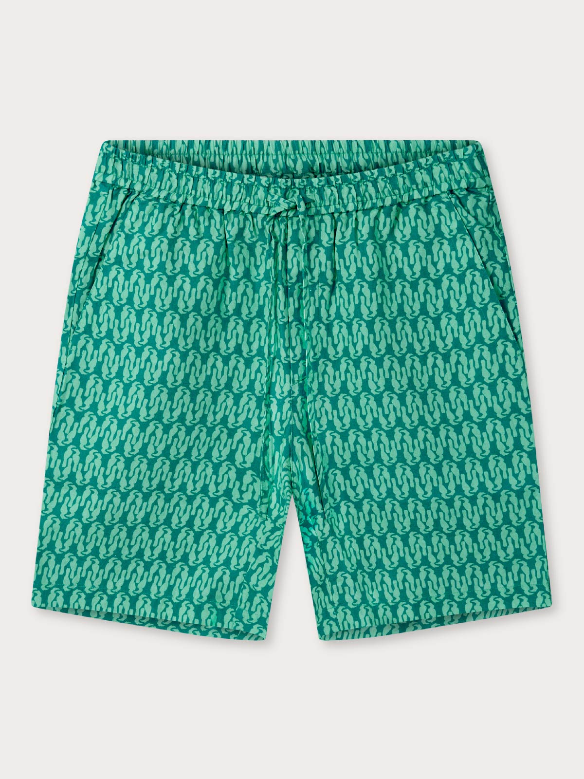 Front view of green shorts with a pattern made from linen on a white background