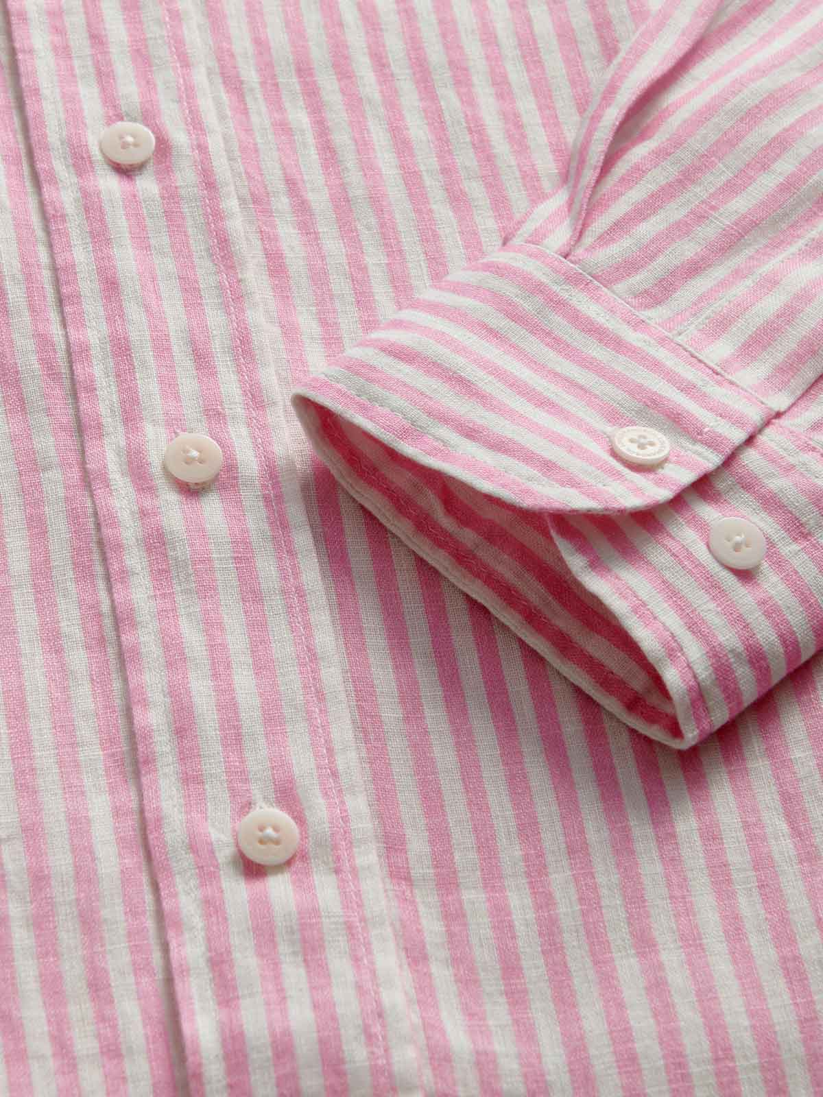 Close-up of a pink and white striped shirt with buttons.