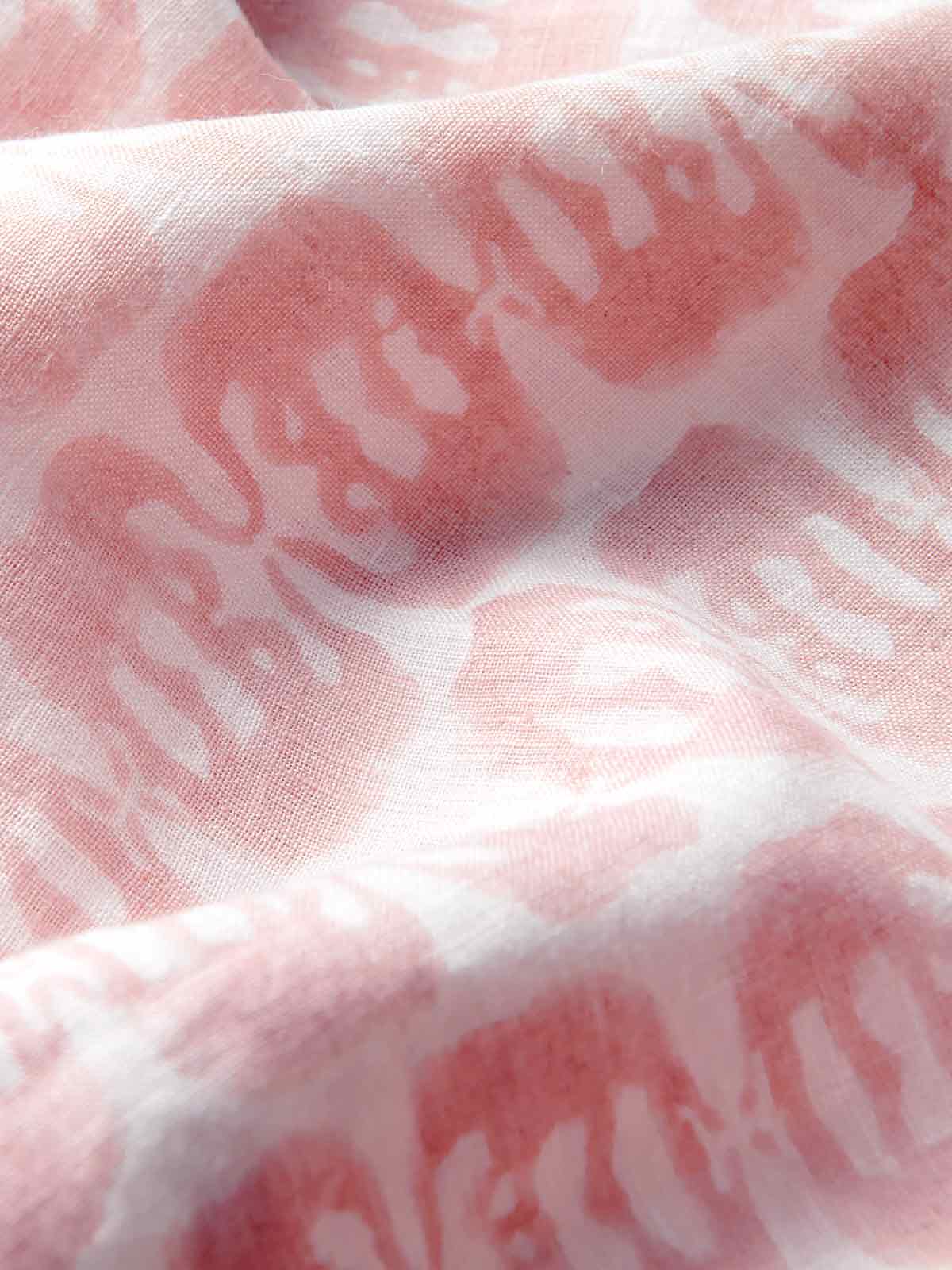 Close-up of pink linen trousers showing elephants of india print and premium linen fabric.