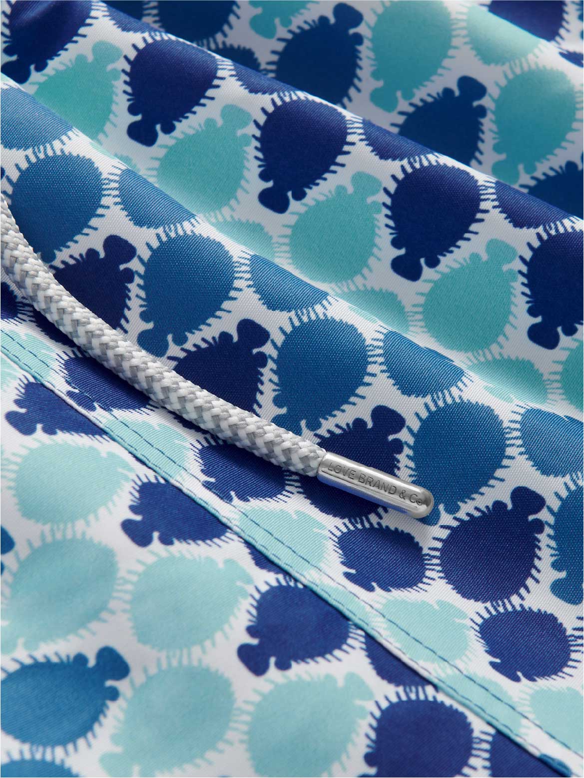 Close-up of a blue and white patterned fabric with a puffer fish print