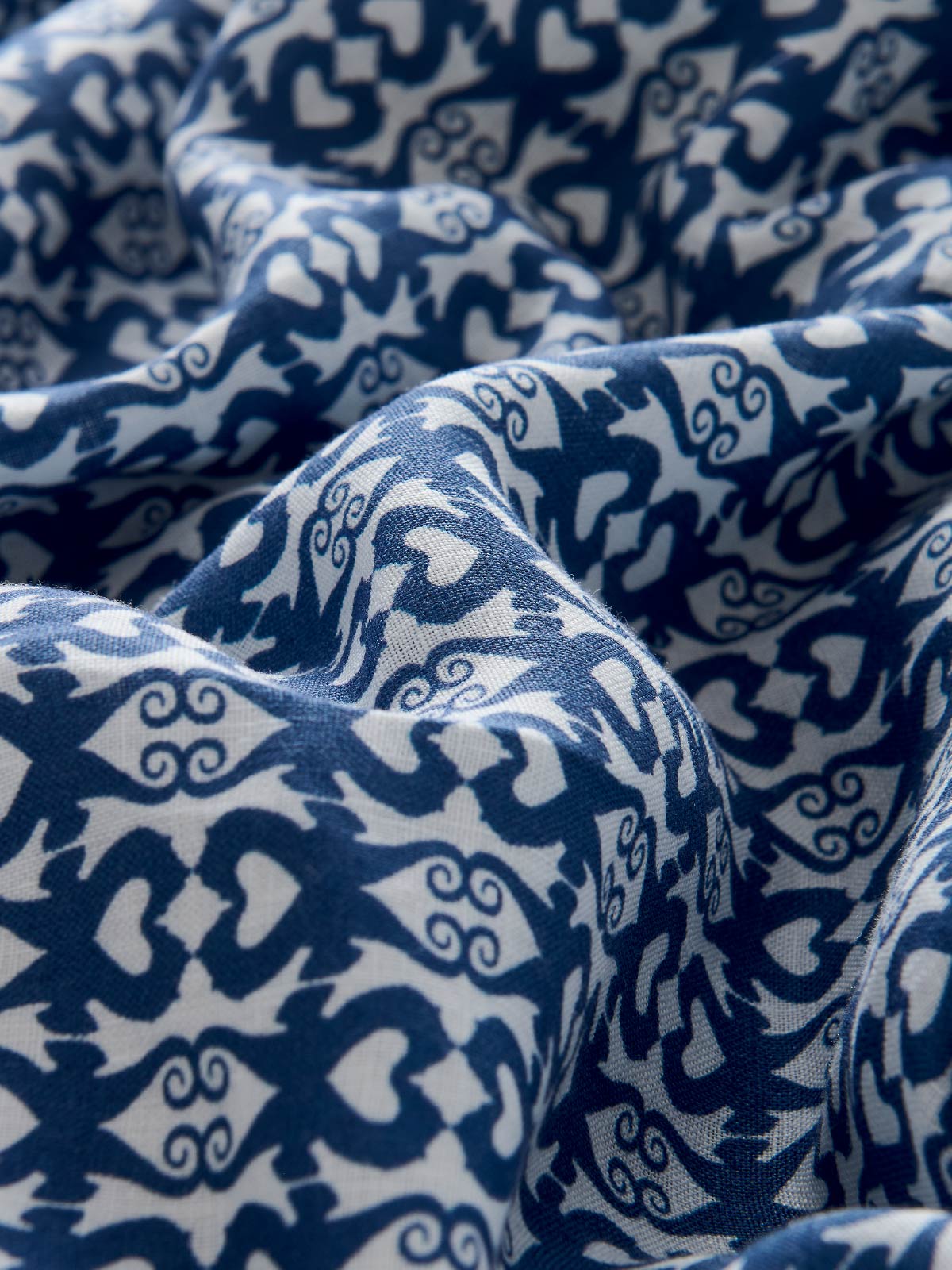 mens linen pants close-up of blue seahorse fabric.