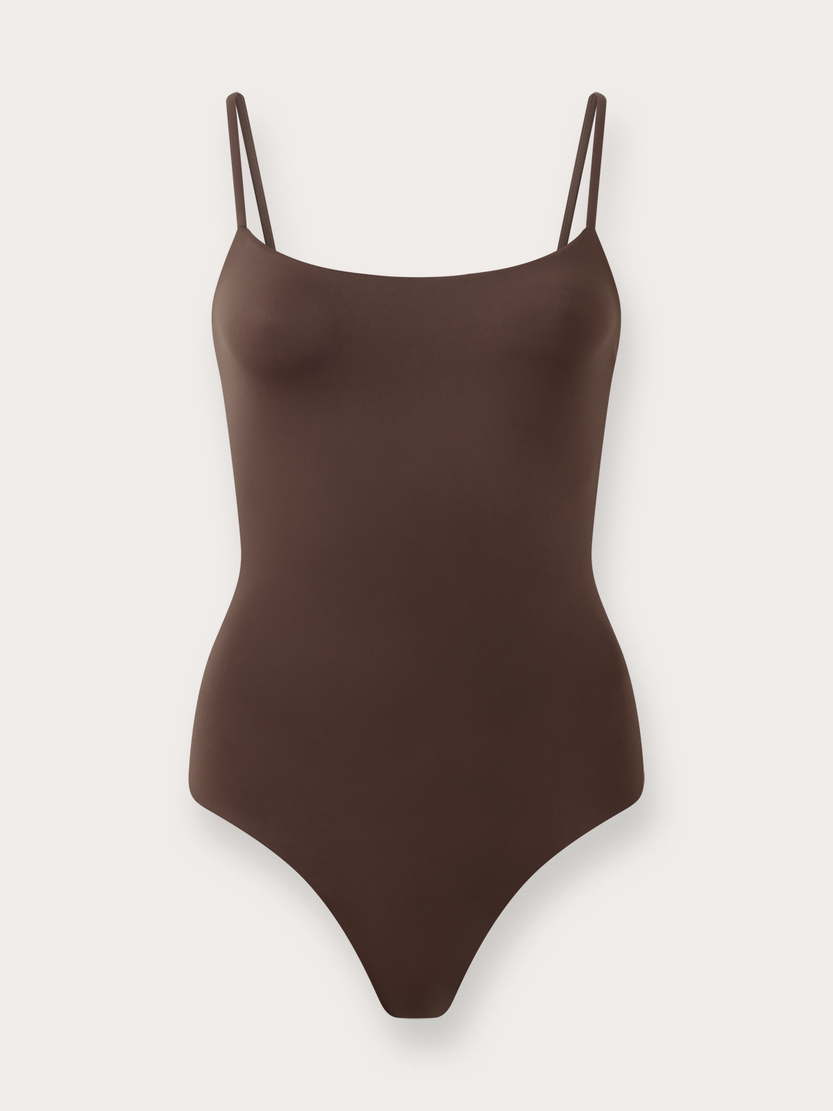 Brown swimsuit with thin straps on a light grey background