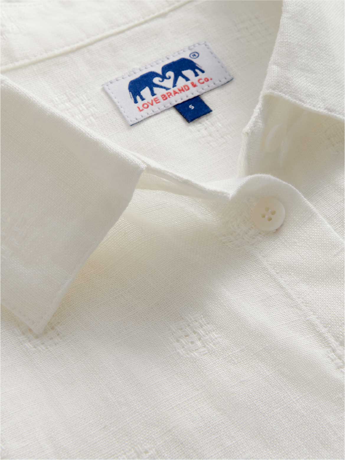 close-up of textured cream linen shirt.