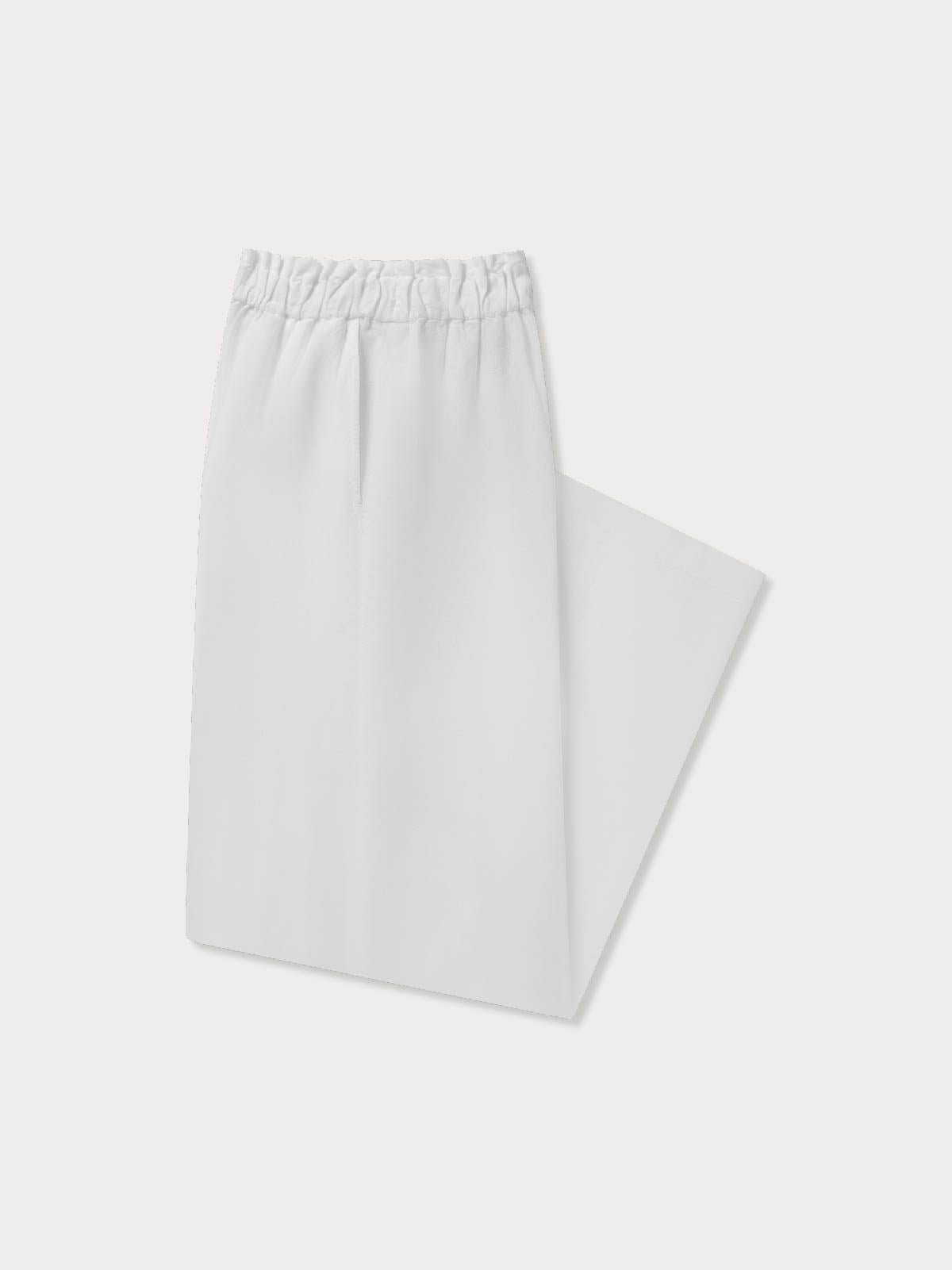 Side view of a folded pair of white linen pants for women.