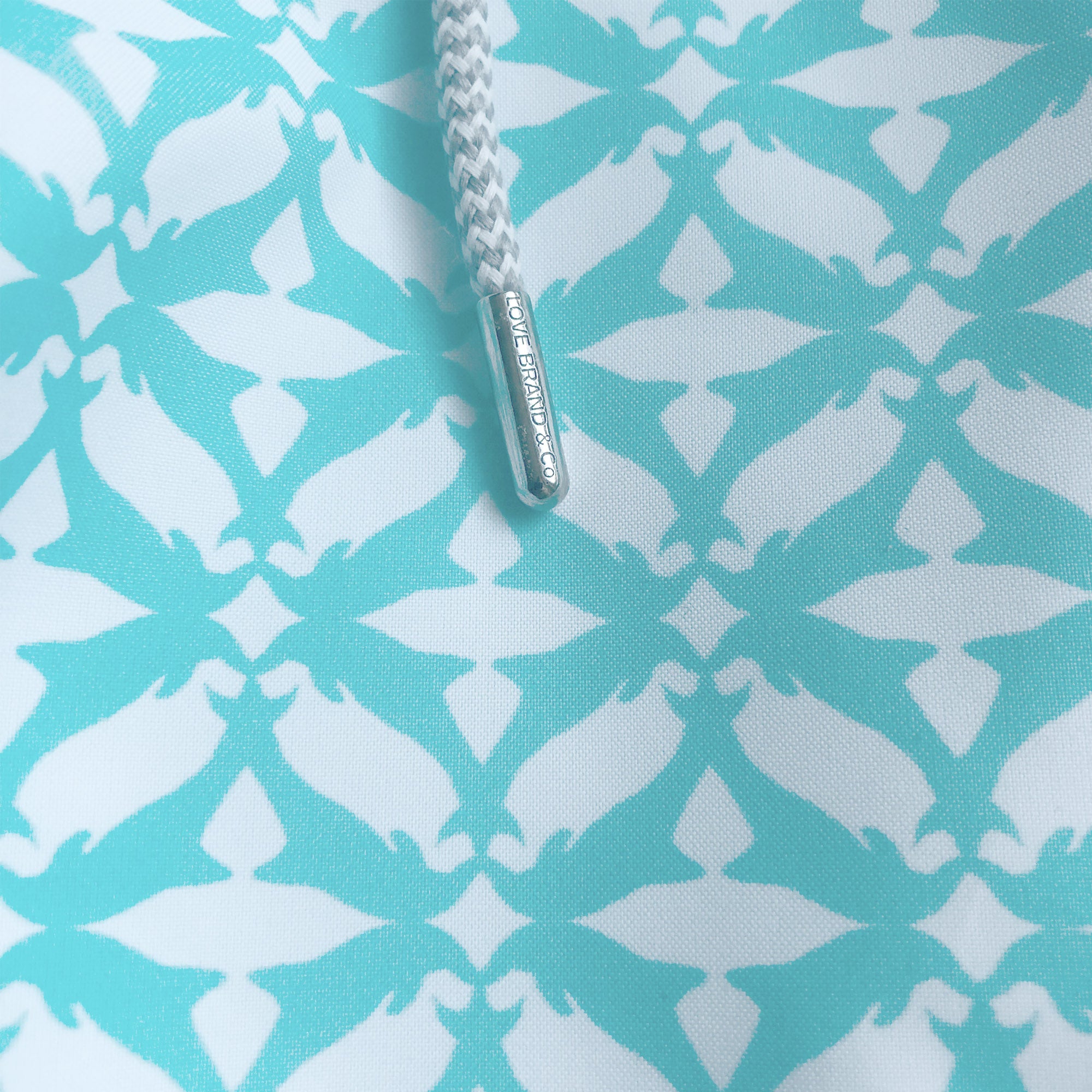 Men's swim shorts with an aqua green jumping dolphin print inspired by bottle nose dolphins in the Mediterranean Sea.