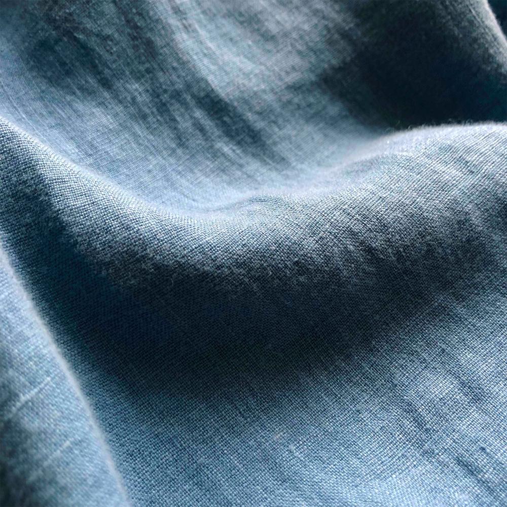 Men's French Blue Abaco Linen Shirt fabric in dusty blue, with a smooth and almost denim-like tone.