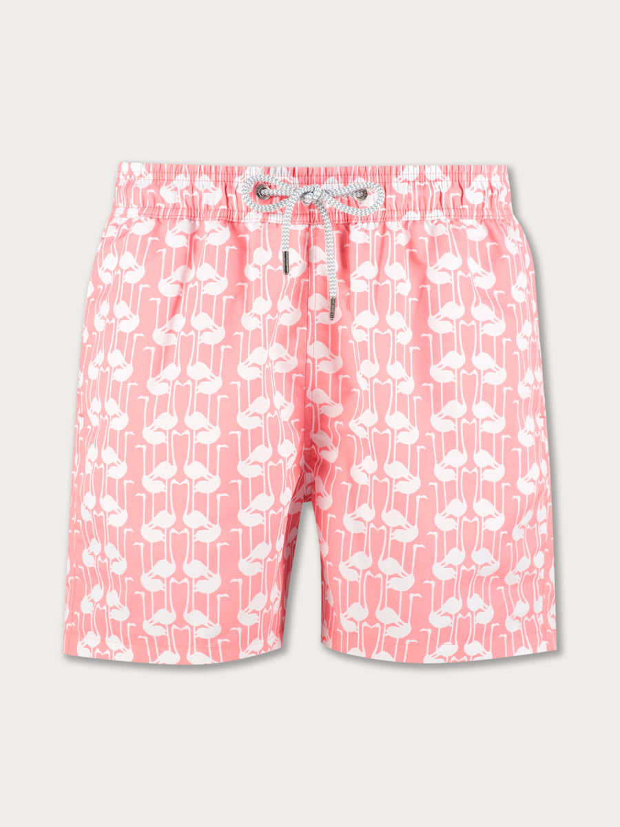 A pair of pink swim shorts with a flamingo pattern and a drawstring waist.