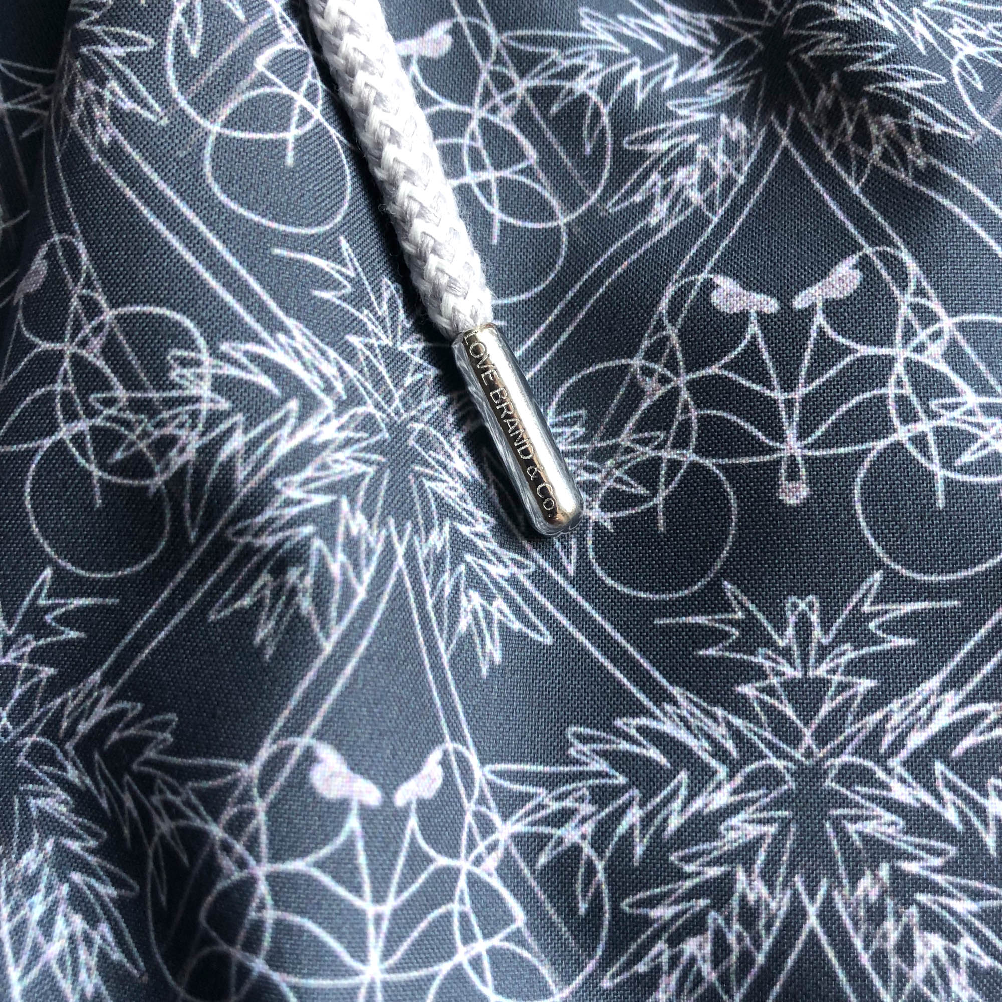 grey swim shorts with palm tree print