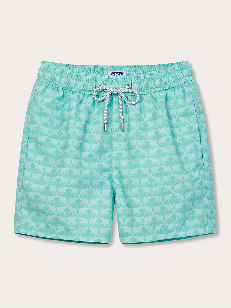 A pair of mint green swim shorts with a pattern of hand-drawn elephants dancing trunk to trunk, featuring a drawstring waistband.