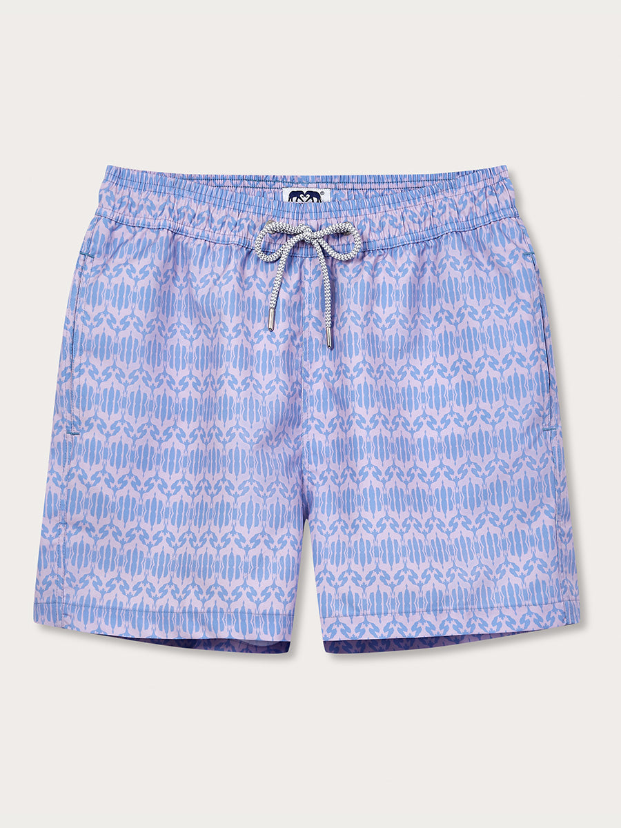 Men's Head in the Clouds Staniel Swim Shorts featuring a pastel lavender and blue giraffe geometric pattern inspired by the Rothchild giraffe and Tusk Trust's conservation work.