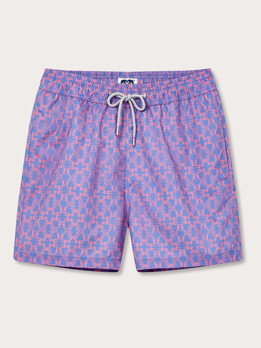 A pair of purple swim shorts with a geometric pattern of coral reefs.