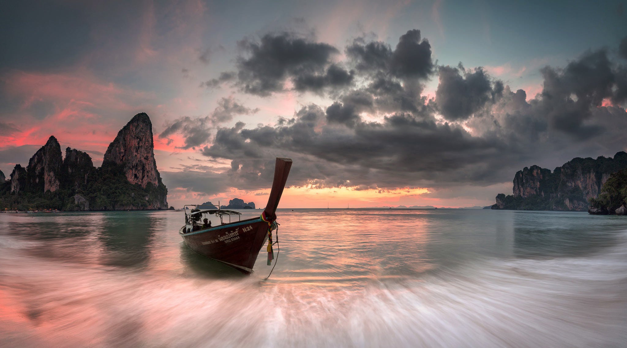 The best sunsets featured image showing the sun setting over Railay Beach, Thailand