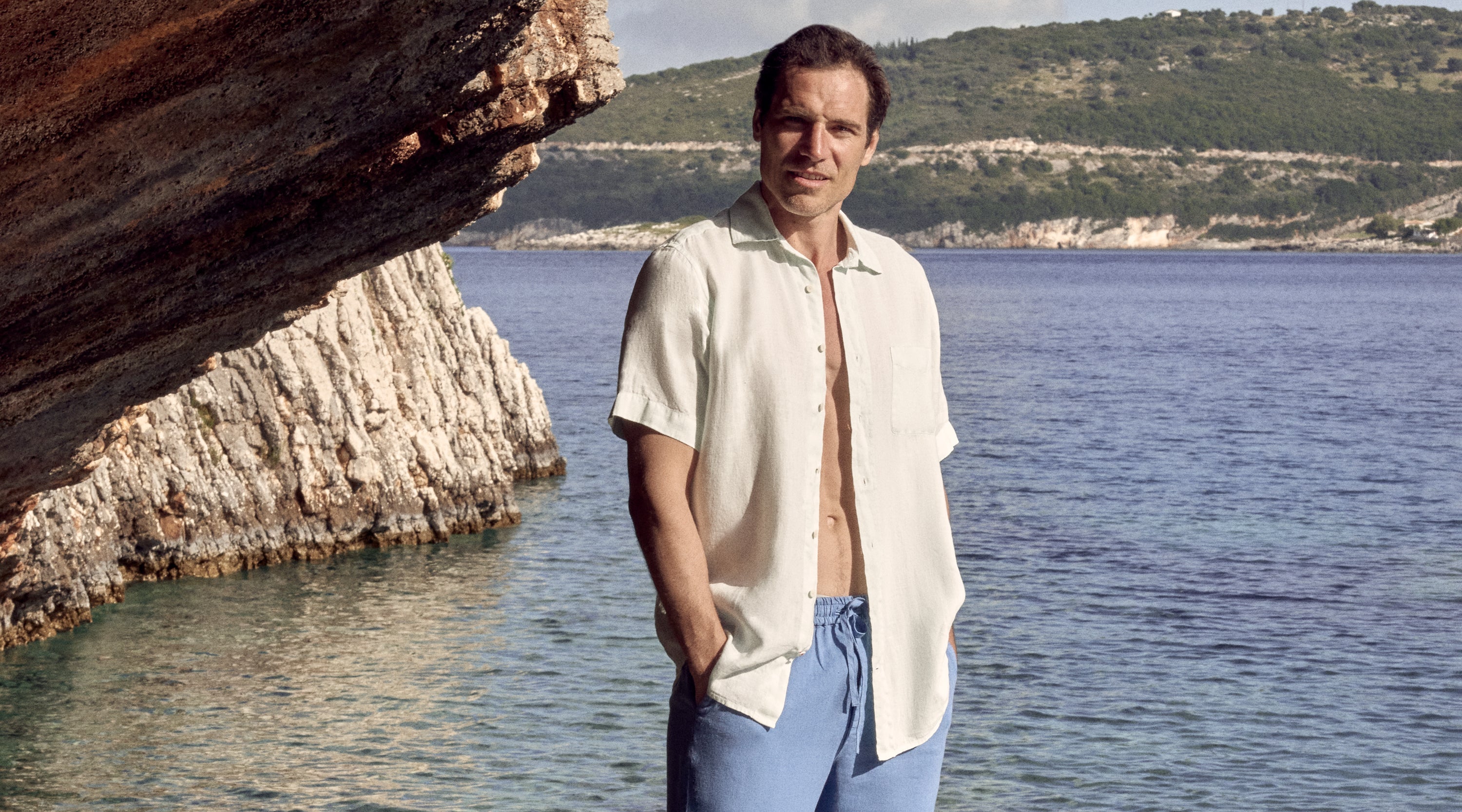 Model wears white oversized beach shirt