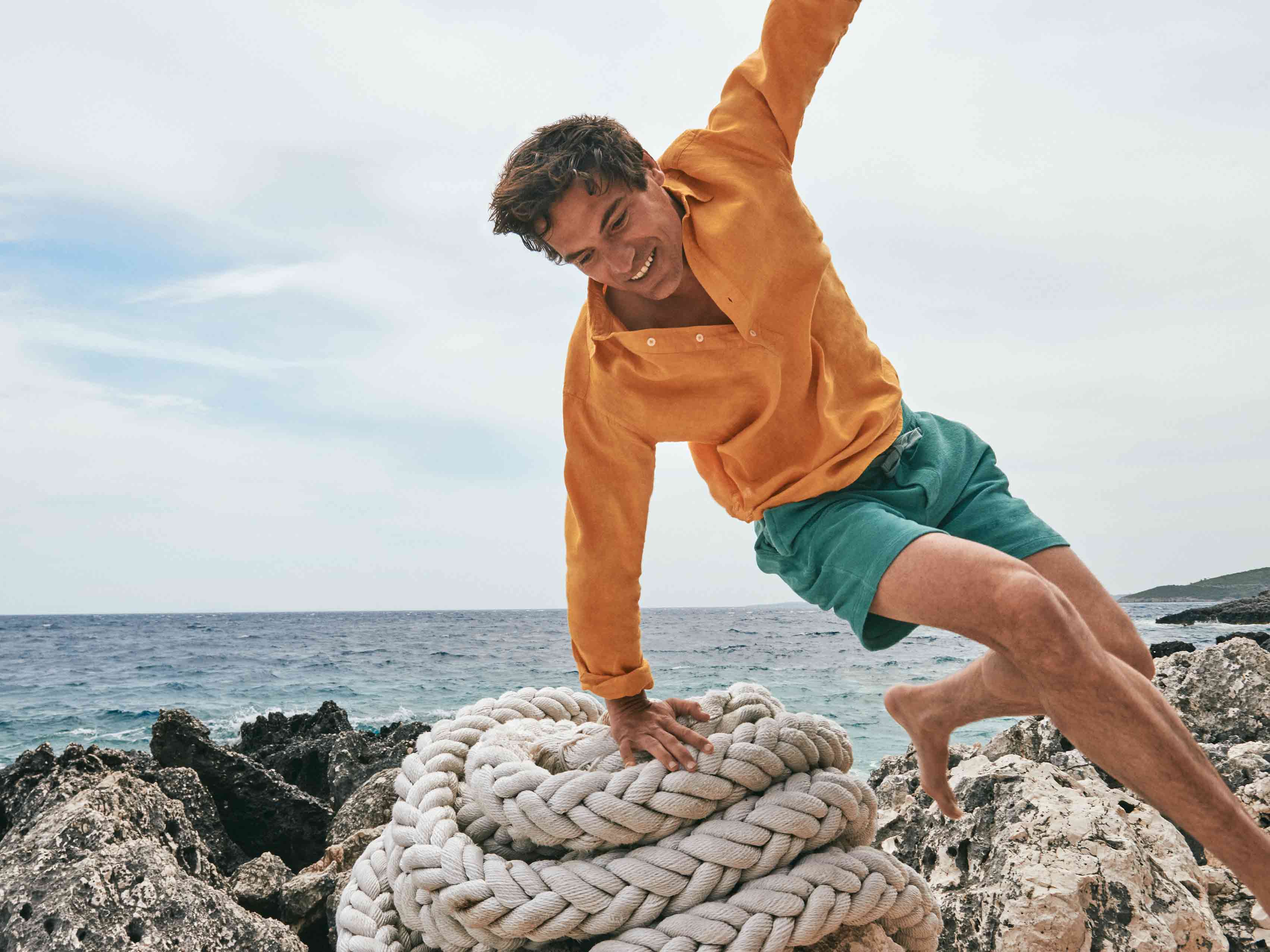 Model wears love brand green terry cloth shorts 