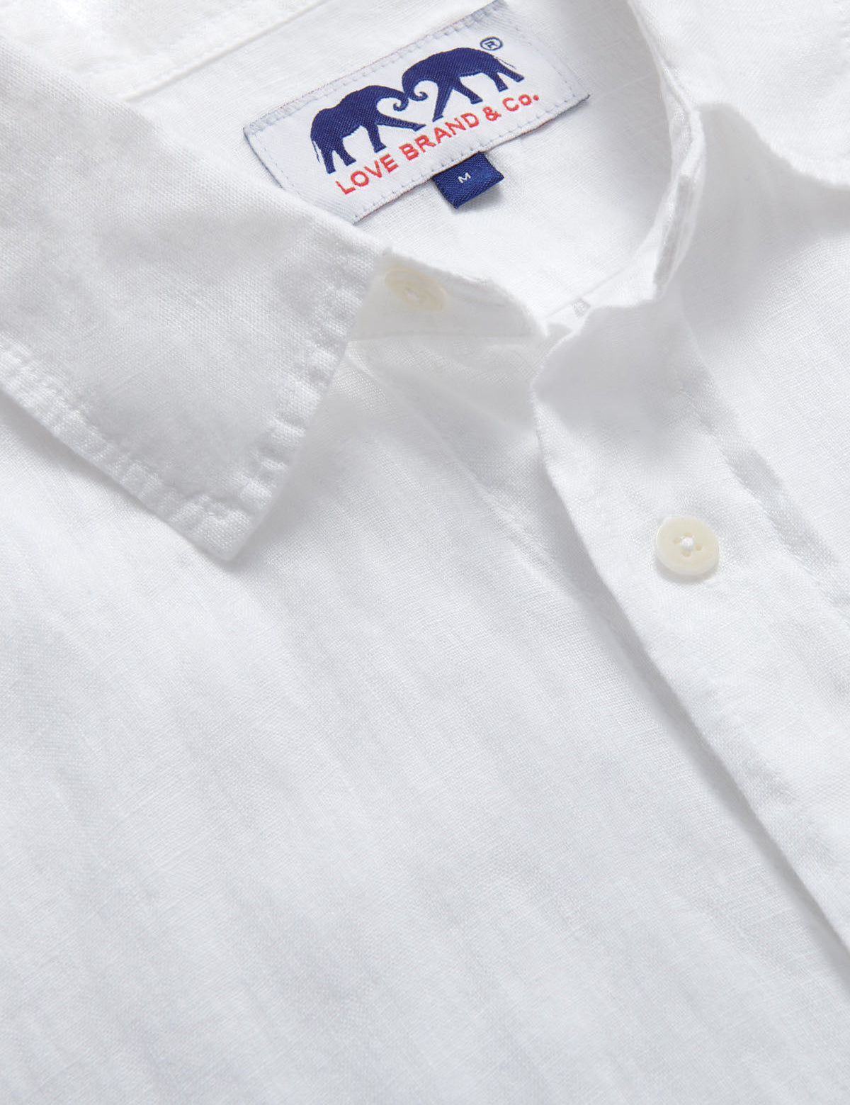 Close-up view of Abaco Mens White Linen Shirt. Detailed view of the label of this mens linen shirt.