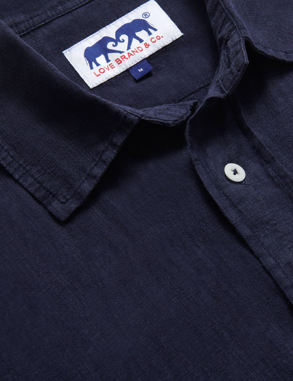 Abaco  Navy Blue mens Linen Shirt close-up view. Mens linen shirt showing navy blue colour and love brand & co logo label.