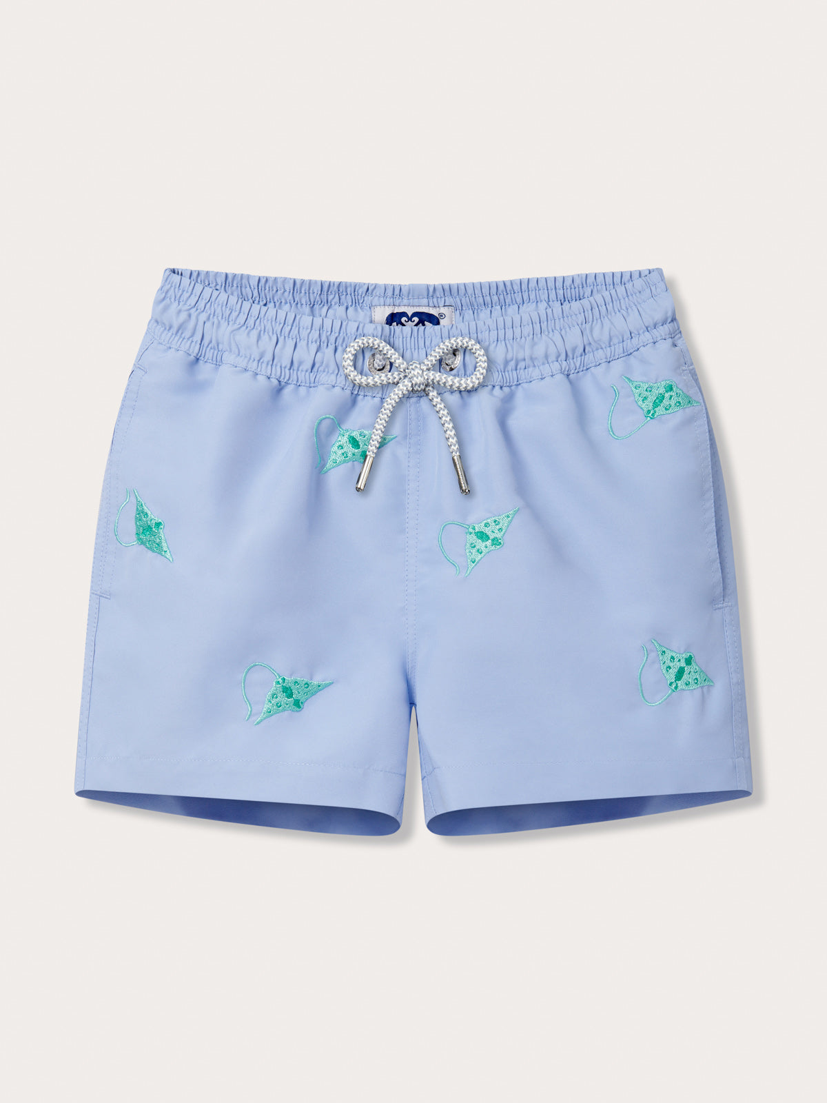 Light blue kids swim shorts with turquoise embroidered manta rays and a drawstring waistband.