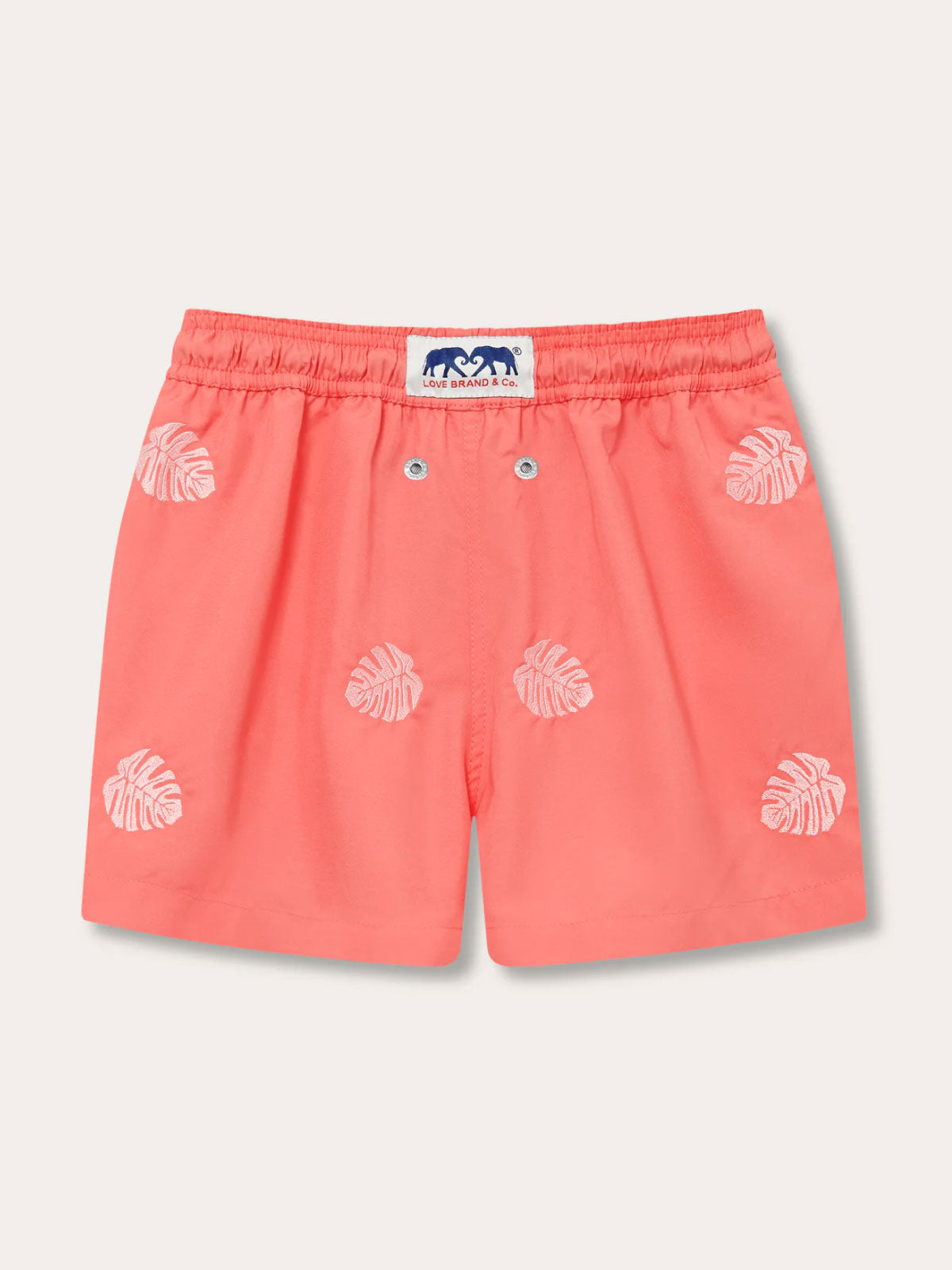 Boys Deliciosa Embroidered Staniel Swim Shorts - Coral Rose base with pink monstera deliciosa leaves, made from 100% recycled polyester, quick-dry fabric for beach and pool.