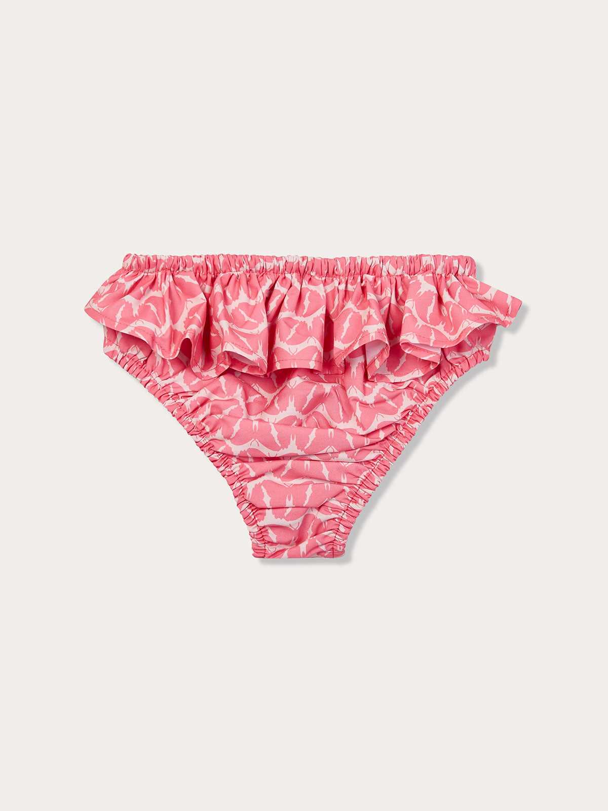 Pink Calabash baby bottoms with ruffles by Girls Fly With Me, made from recycled plastic-based materials.