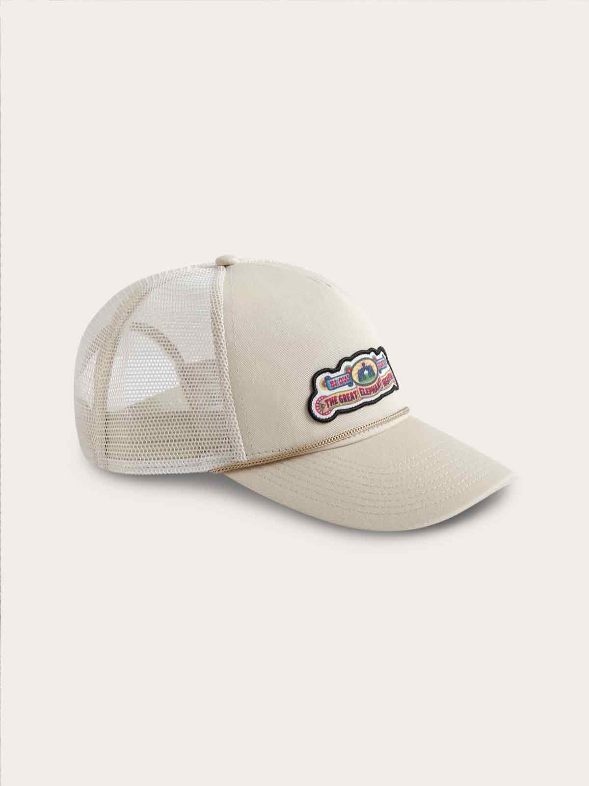 Stone-colored adjustable trucker cap with The Great Elephant Migration logo, merrowed edge label, cotton twill front, tonal mesh back, and 5-panel high crown with a slightly curved visor.