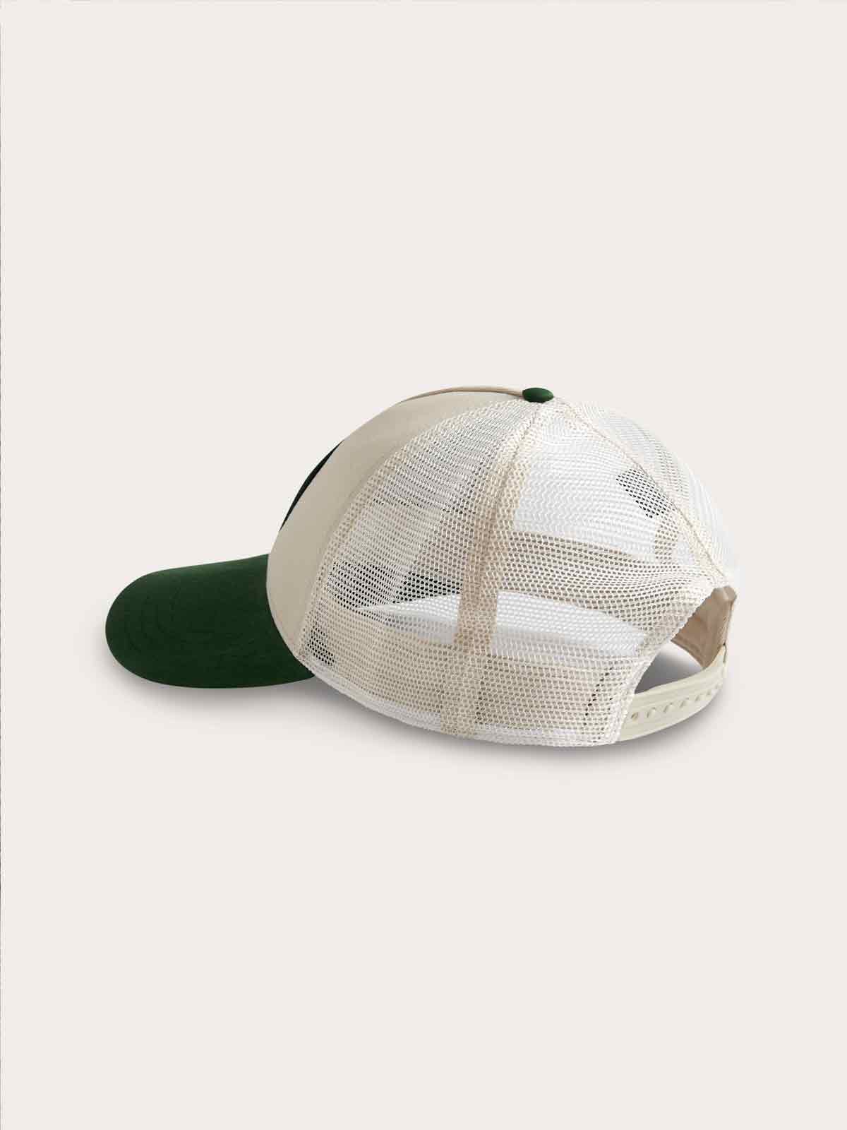 Trucker cap in stone and forest green with mesh back, adjustable strap, and slightly curved visor.