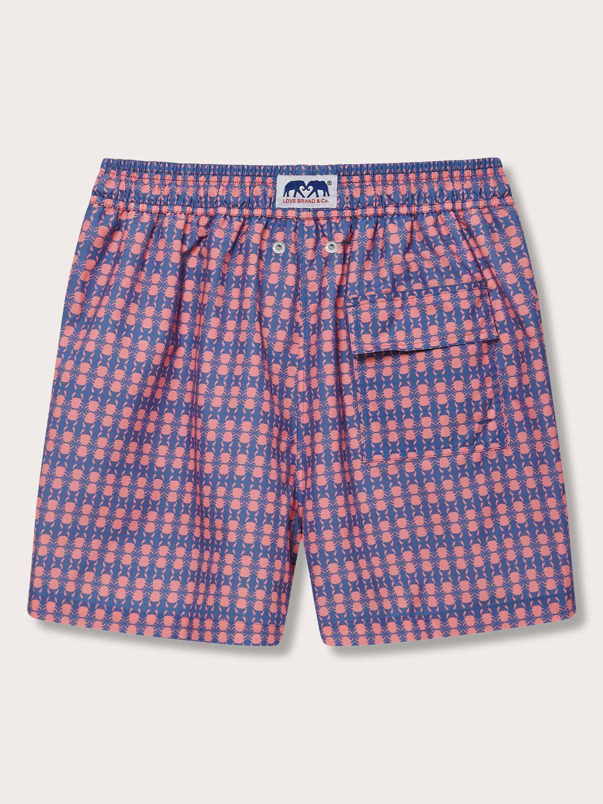 Men's Crab Pool Staniel Swim Shorts with pink crabs and watermelon print on a deep blue background.