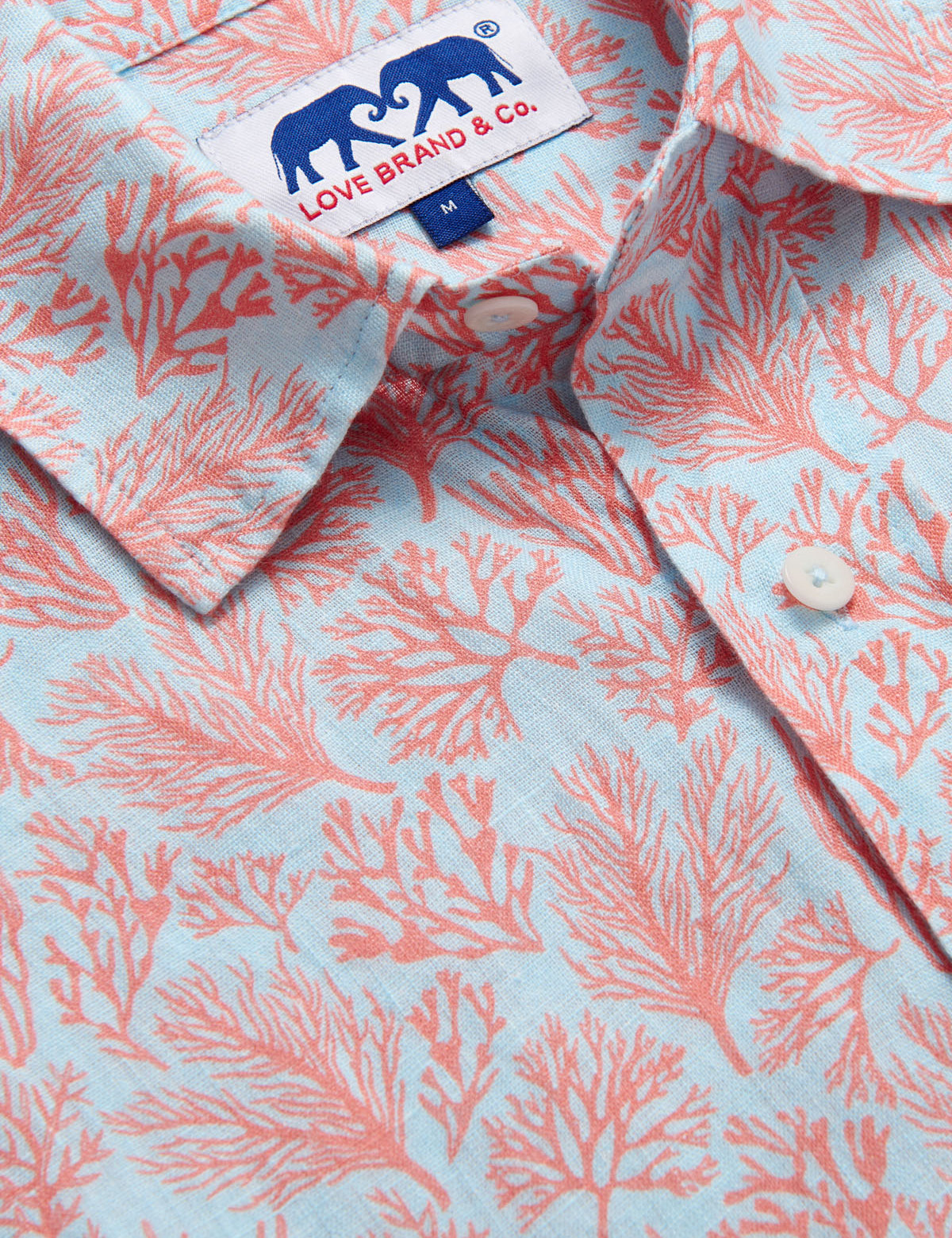 Crazy Coral Abaco mens Linen Shirt detailed view. Close up of a blue and coral mens linen shirt.