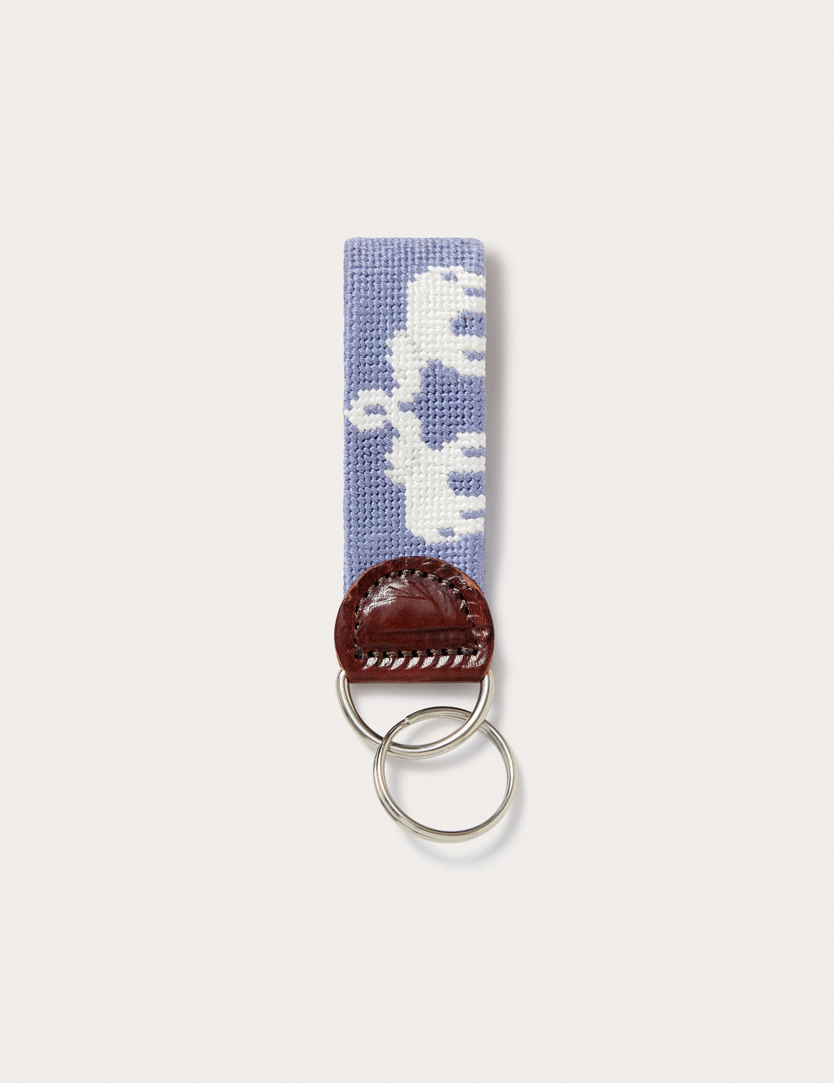 Needlepoint keyring featuring Asian elephants with trunks up forming the illusion of Indian palaces, crafted with blue needlepoint and finished with genuine leather and a brass clasp.