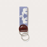 Needlepoint keyring featuring Asian elephants with trunks up forming the illusion of Indian palaces, crafted with blue needlepoint and finished with genuine leather and a brass clasp.