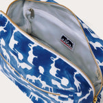 Canvas wash bag in blue featuring a block-printed pattern of Asian elephants forming the illusion of Indian palaces; shown with an open zipper displaying internal compartments and a recycled plastic lining.