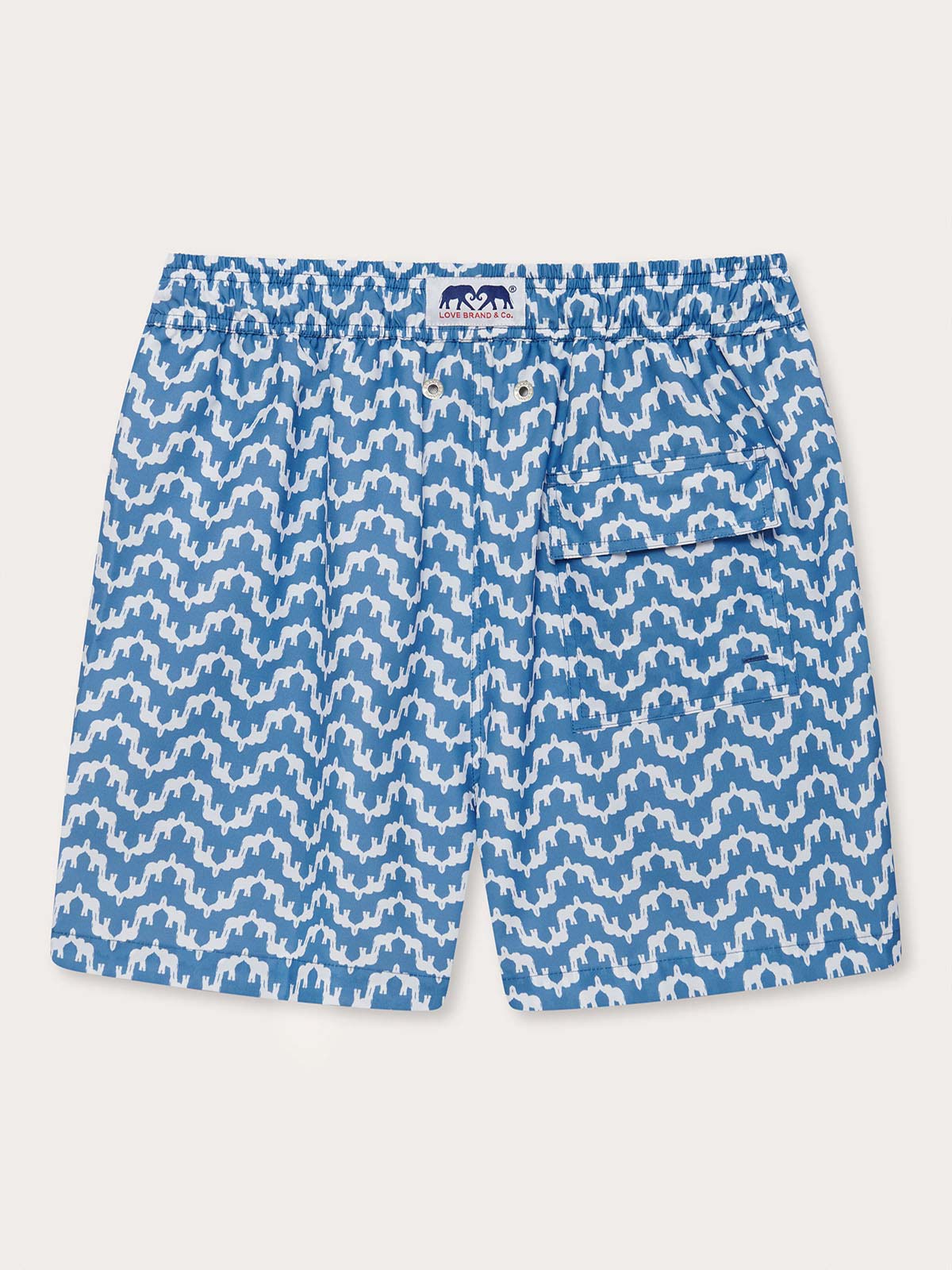 elephant palace blue mens swim shorts. This patterned swim shorts design features white elephants raising their trunks to create a pattern that resembles Indian palaces on a blue background.