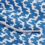 Elephant Palace Blue Staniel mens Swim Shorts detailed view. This patterned swim shorts design features white elephants raising their trunks to create a pattern that resembles Indian palaces on a blue background.