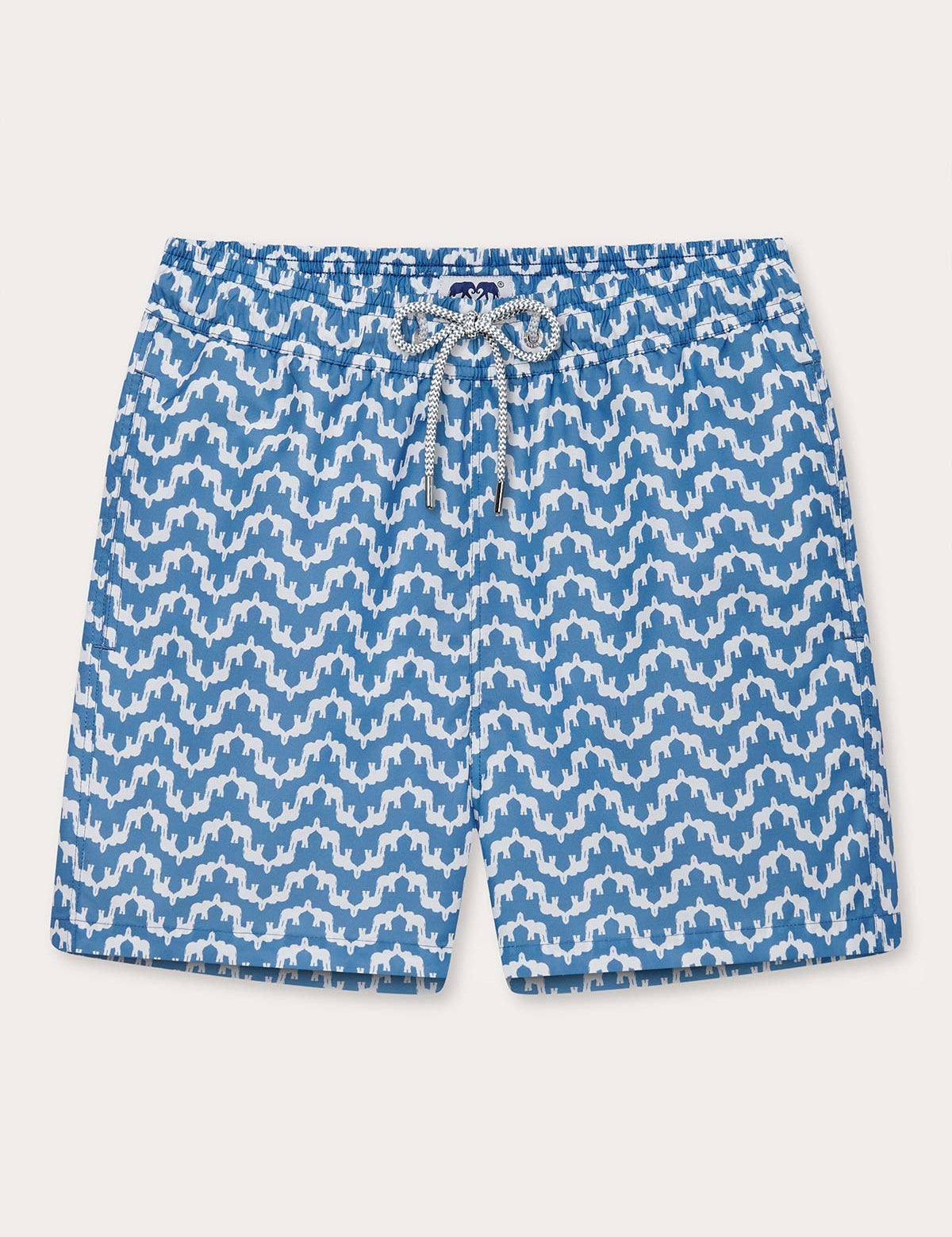 Elephant Palace Blue Staniel mens swim shorts front. Patterned swim shorts featuring white elephants raising their trunks to create a pattern that resembles Indian palaces on a blue background.