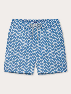 Elephant Palace Blue Staniel mens swim shorts front. This design features white elephants raising their trunks to create a pattern that resembles Indian palaces on a blue background.