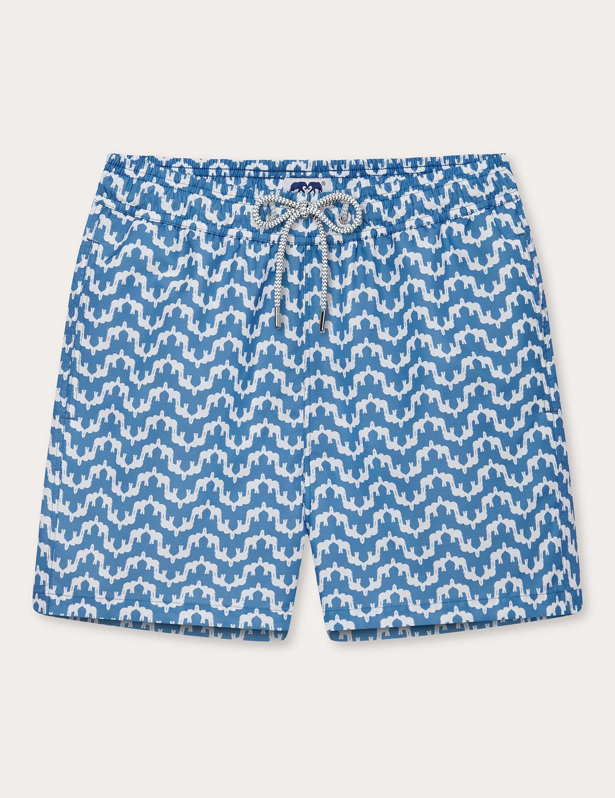 Elephant Palace Blue Staniel mens swim shorts front. This design features white elephants raising their trunks to create a pattern that resembles Indian palaces on a blue background.