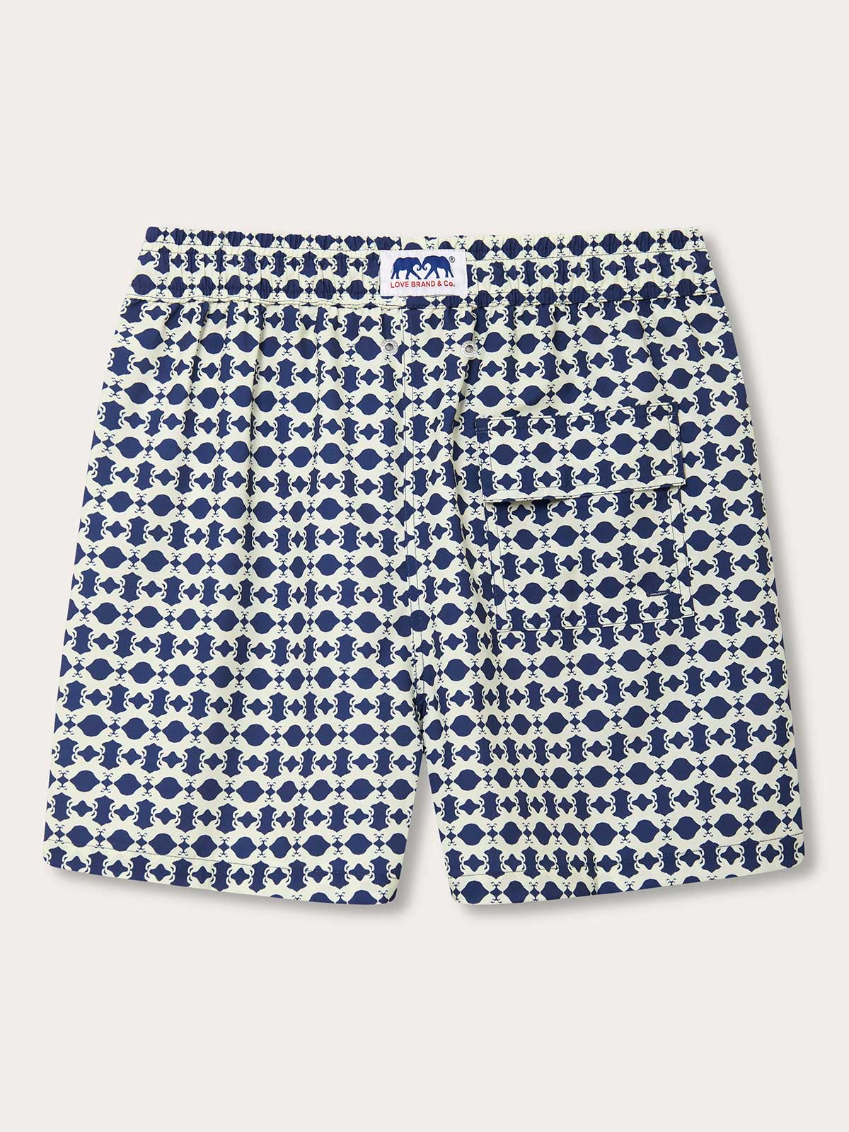 Back view of the Eye Of The Tiger mens swim shorts. These patterned swim shorts show Sumatran Tigers hidden amongst a geometric print in a vintage tone of stone and Chambray Blue.