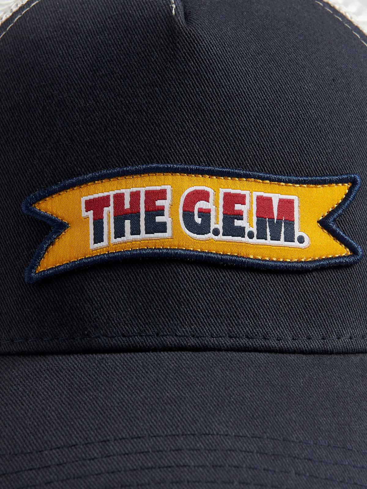 Navy blue trucker cap with "The G.E.M." logo label on the front.