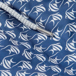 Close-up of Men's Go With the Flow Staniel Swim Shorts. Patterned swim shorts featuring a Moorish Idol fish print on a deep blue background.