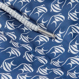 Close-up of Men's Go With the Flow Staniel Swim Shorts. Patterned swim shorts featuring a Moorish Idol fish print on a deep blue background.