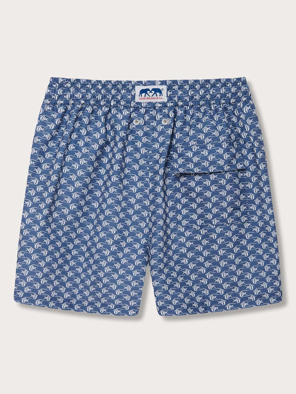 Men's Go With the Flow Staniel Swim Shorts. Patterned swim shorts featuring Moorish Idol fish print on a deep blue background, crafted from 100% recycled, quick-dry material.