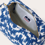 Canvas wash bag in blue featuring a block-printed pattern of Asian elephants forming the illusion of Indian palaces; shown with an open zipper displaying internal compartments and a recycled plastic lining.