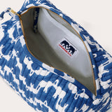 Canvas wash bag in blue featuring a block-printed pattern of Asian elephants forming the illusion of Indian palaces; shown with an open zipper displaying internal compartments and a recycled plastic lining.