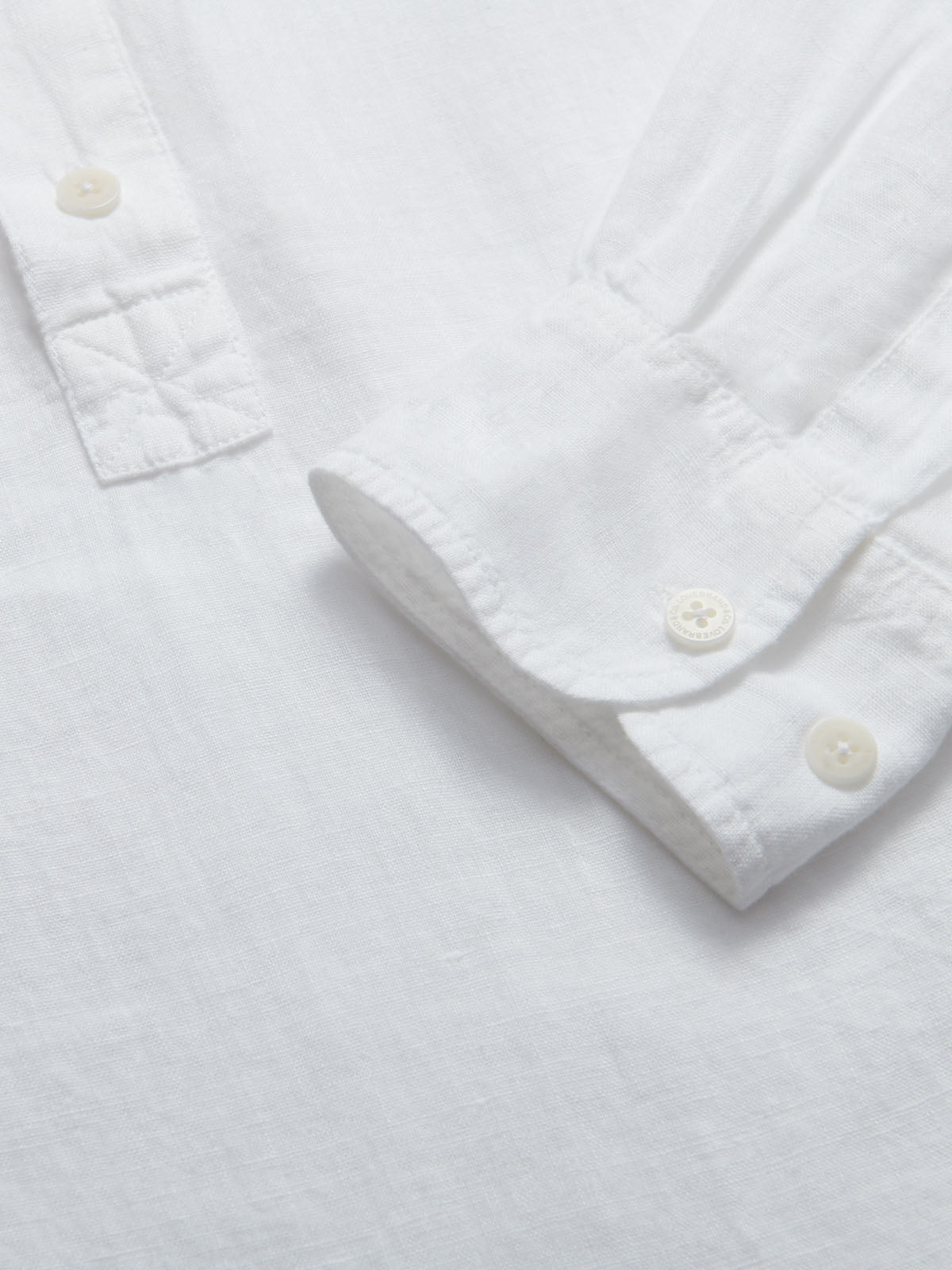 Close-up of Hoffman Mens White Linen Shirt with corozo nut buttons.