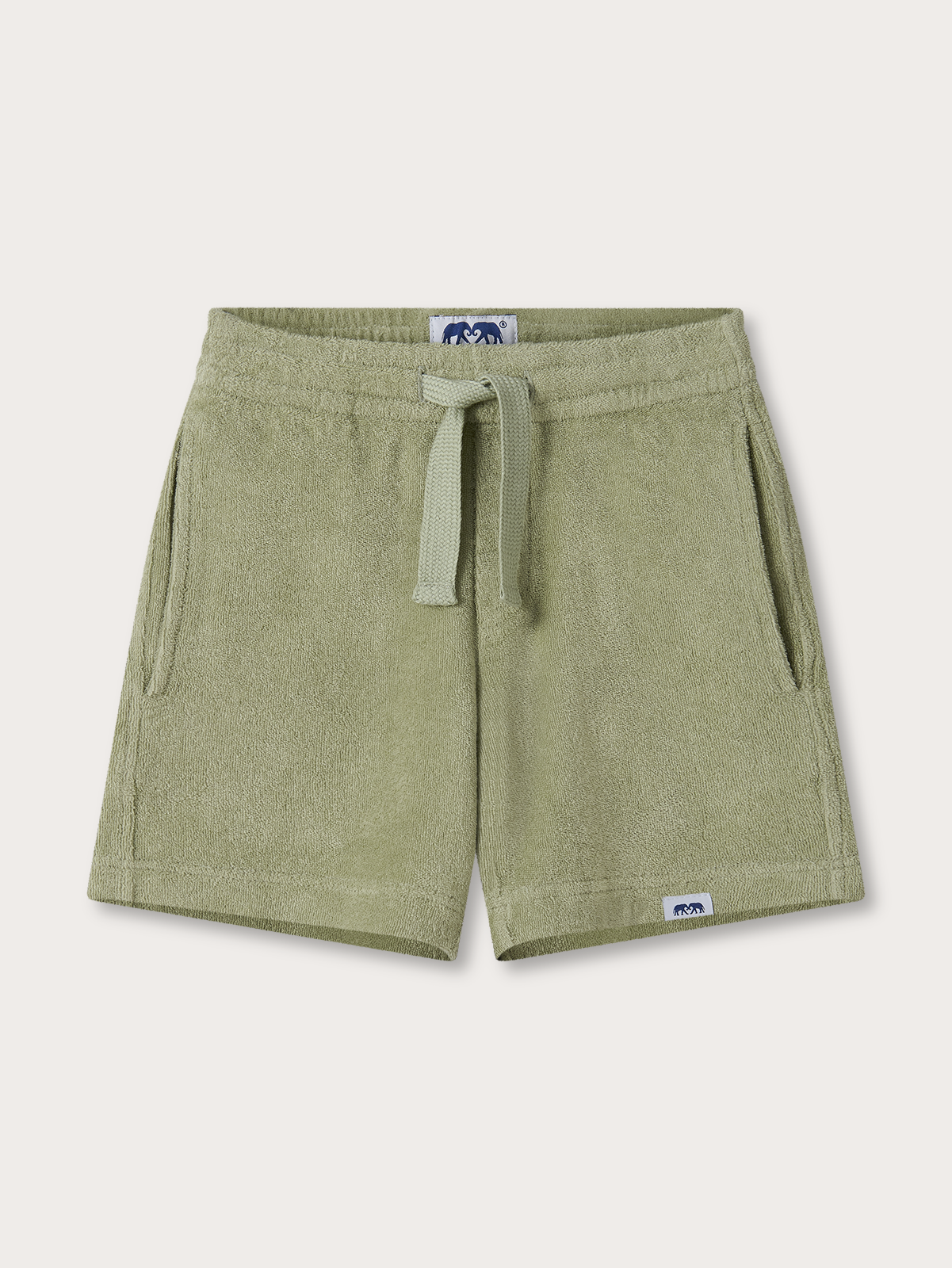 Green kids shorts with a drawstring on a light beige background