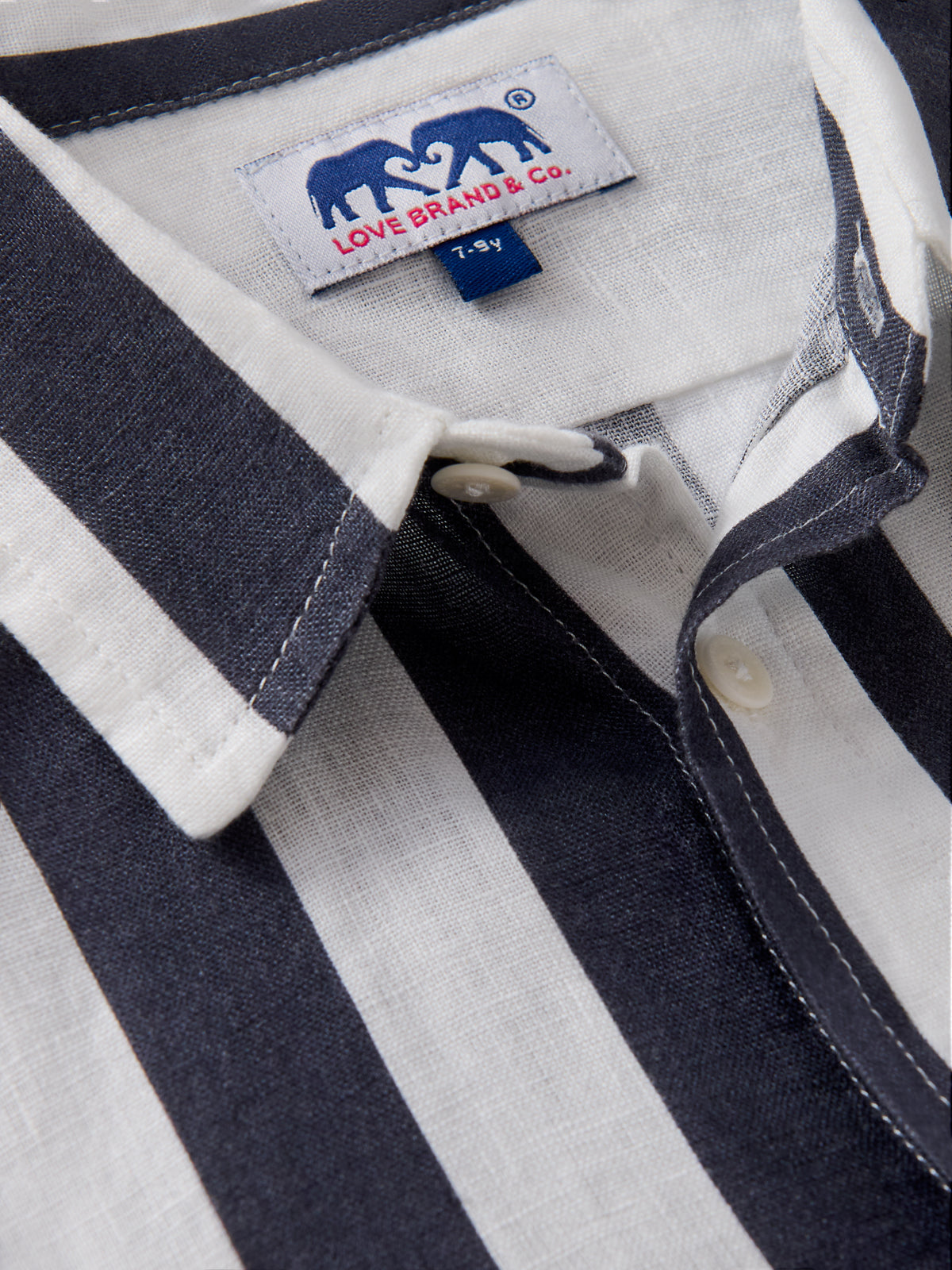 Detailed view of Kids Nevy Lines Abaco Linen Shirt showcasing white and navy stripes.